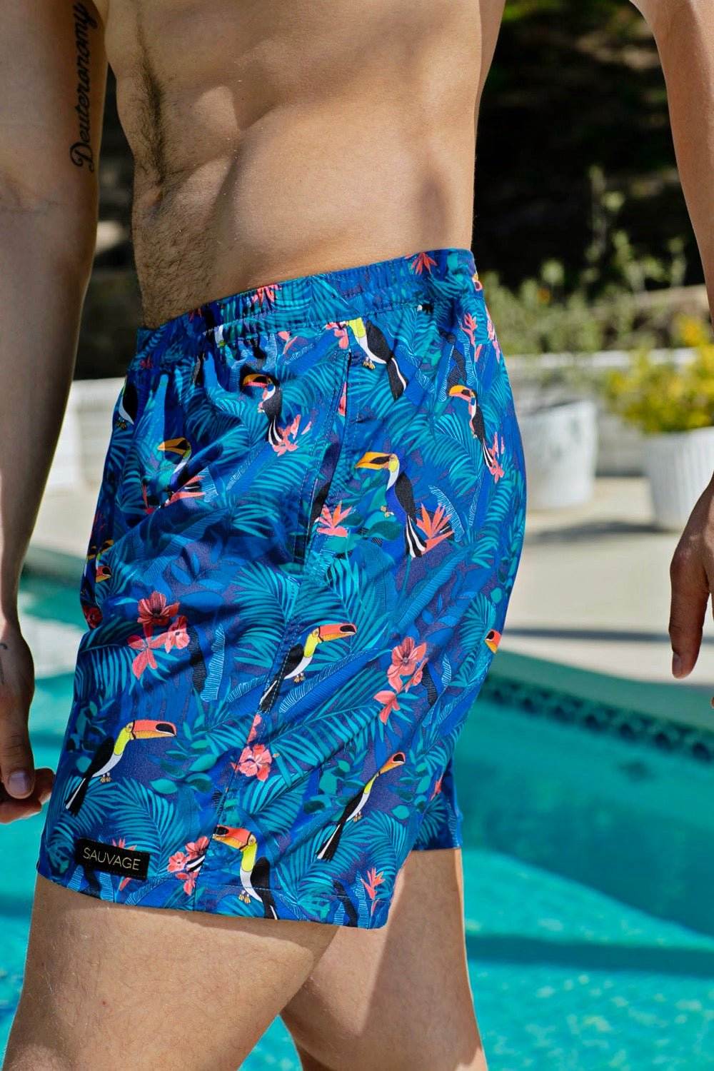 swimsuit model on beach Toucan Trunks